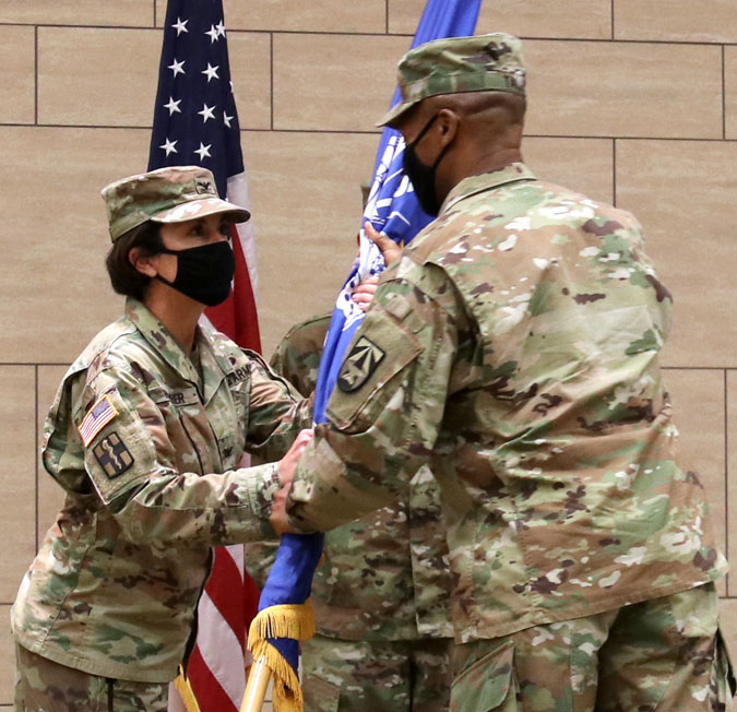 Col. Robin R. Neumeier accepts the flag from Brig. Gen. Michael J. Talley